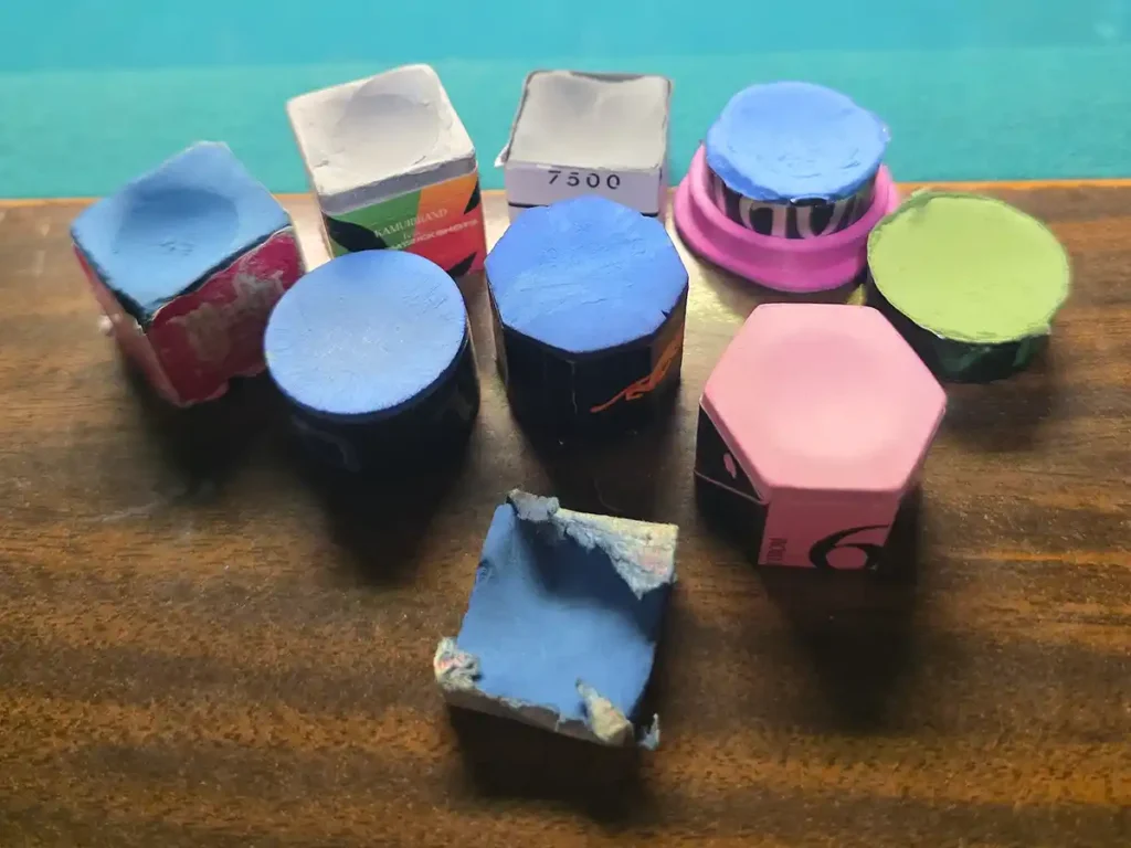 a variety of different pool chalks - kamui, turning point, taom, predator, and masters